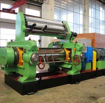 Feeding blend stock into open mixing mill for rubber processing