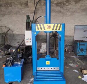 Hydraulic rubber bale cutter machine cutting natural rubber block in industrial factory